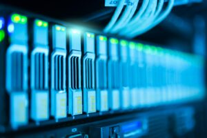 Rack of servers glowing blue with green lights, possibly a Bitcoin mining array